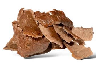 Thinly sliced gyro meat carved from the vertical rotisserie